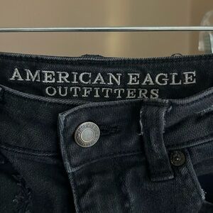 American Eagle black distressed denim in size 0